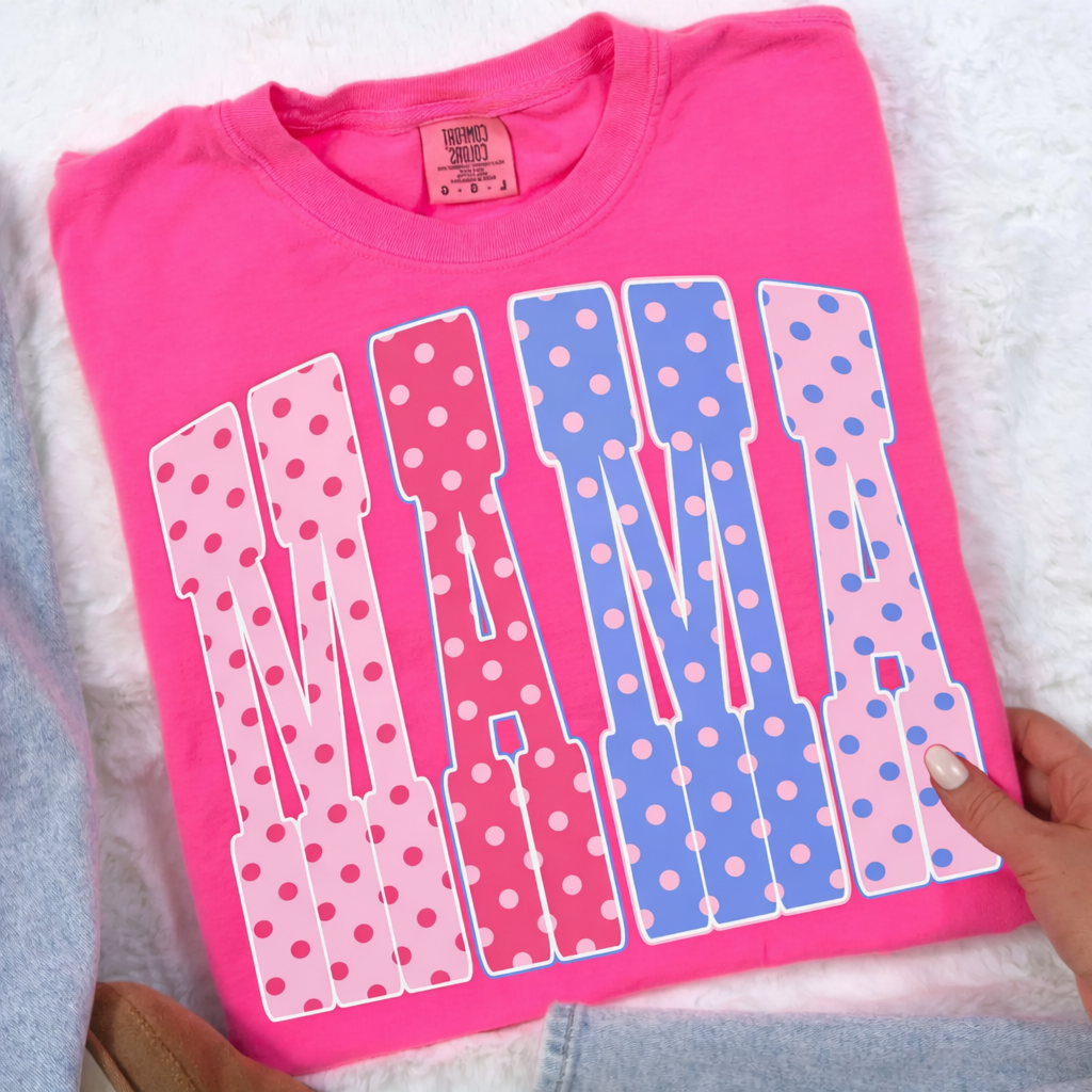 Pink t-shirt with 'MAMA' design on a white surface